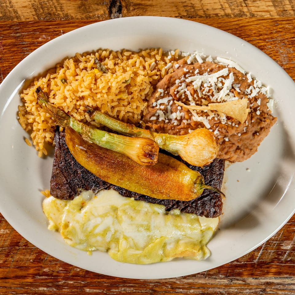 El Camino's Mexican dish with steak, melted cheese, grilled peppers, rice, and refried beans.