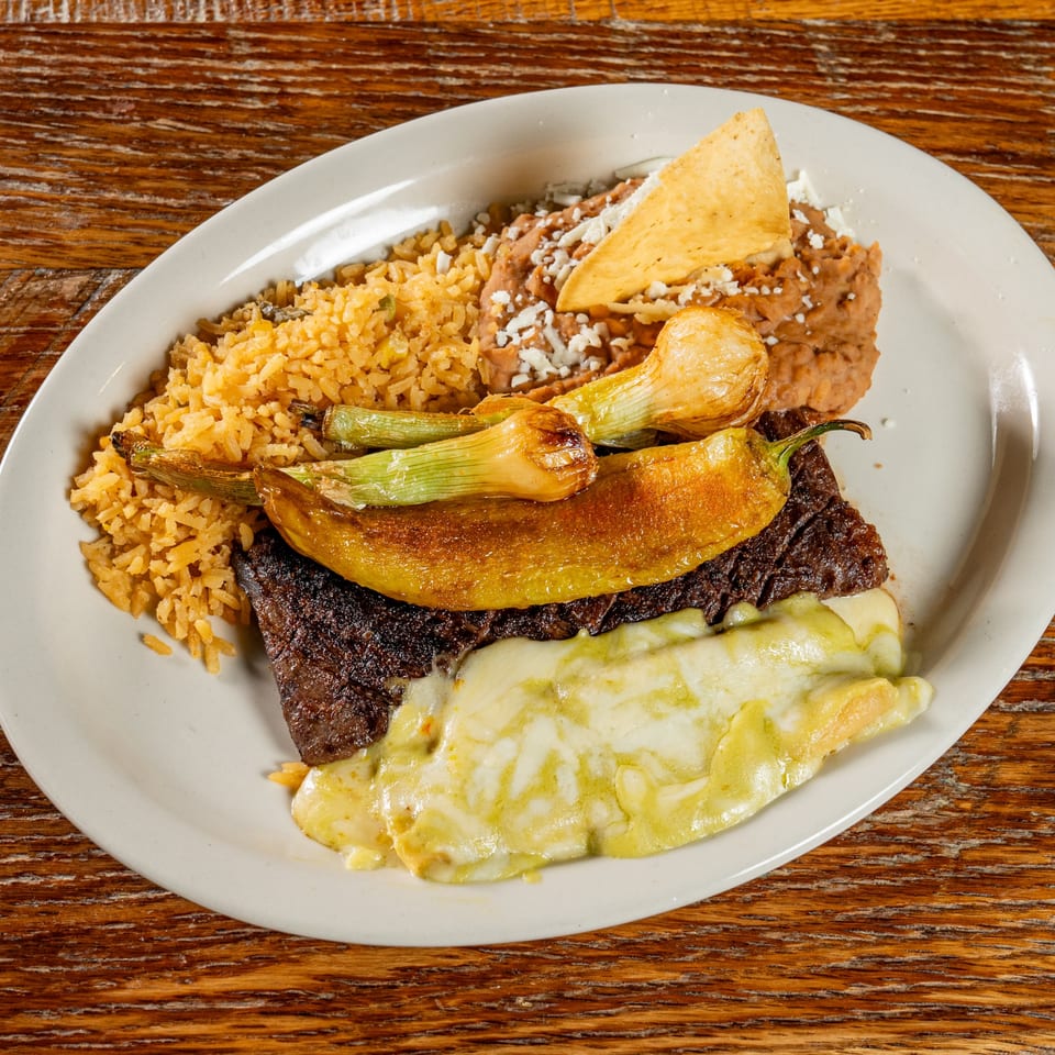 El Camino's Mexican dish with steak, melted cheese, rice, refried beans, and grilled peppers.